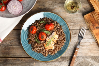 Flat lay composition with tasty buckwheat porridge on wooden table