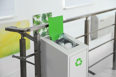 Photo of Metal bin with garbage indoors. Waste recycling