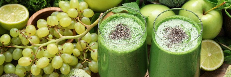 Glasses of fresh green smoothie and ingredients on table. Banner design