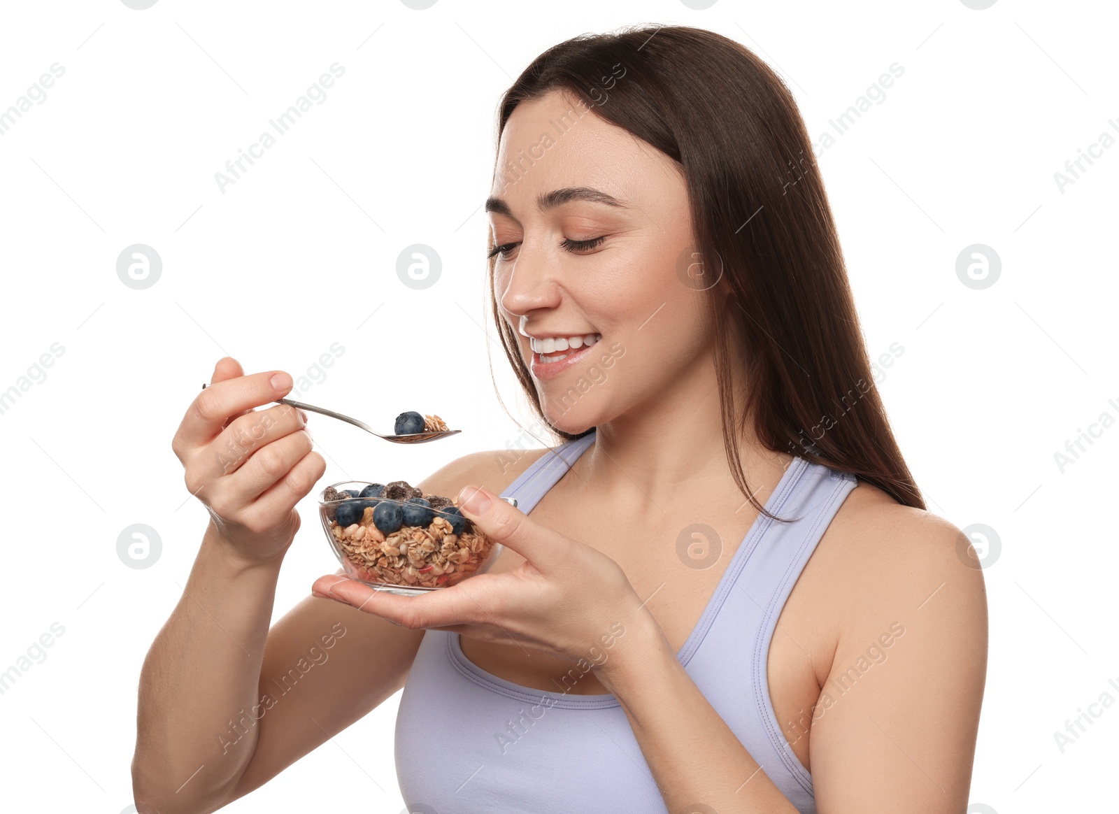 Photo of Happy woman eating tasty granola with fresh berries on white background