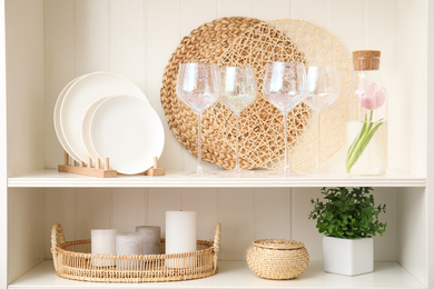 White shelving unit with glasses and different decorative stuff