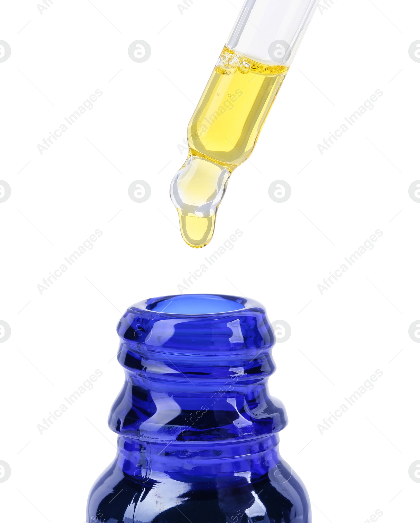 Photo of Dripping tincture from pipette into bottle isolated on white