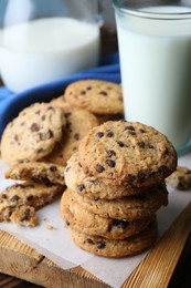 Photo of Delicious chocolate chip cookies and milk on table, closeup