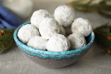 Photo of Tasty snowball cookies in bowl, closeup. Christmas treat