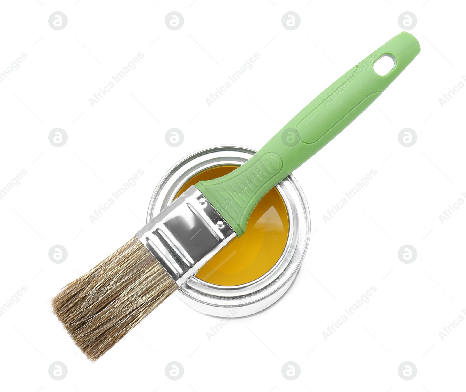 Photo of Can of yellow paint with brush isolated on white, top view