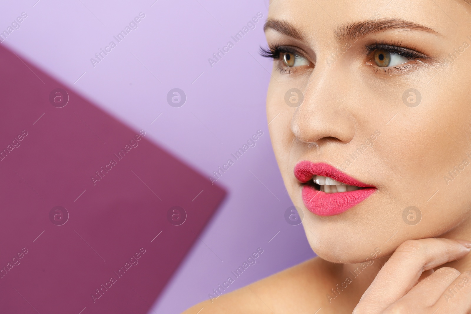 Photo of Young woman wearing beautiful lipstick on color background. Space for text