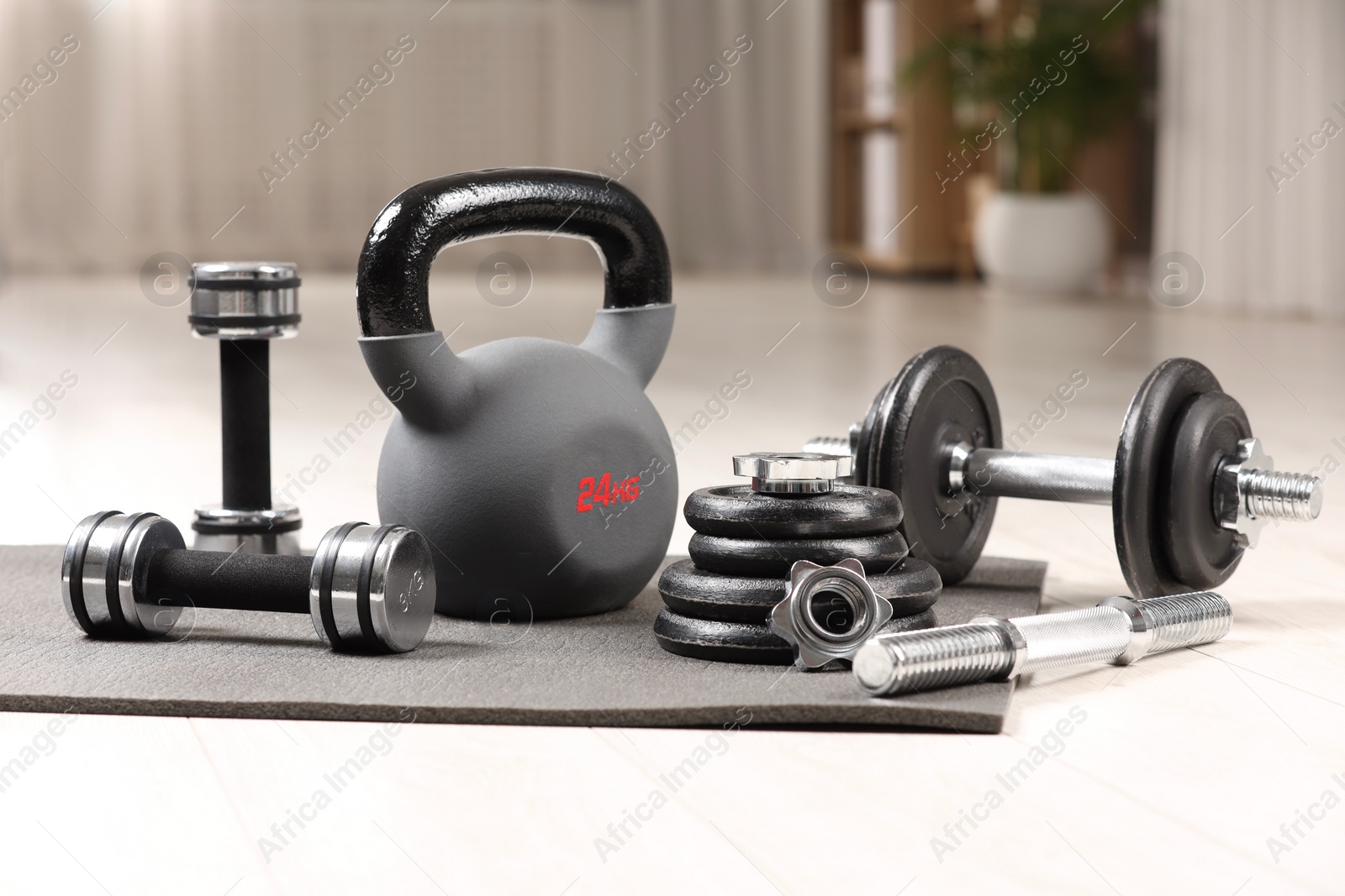 Photo of Many different sports equipment on floor indoors