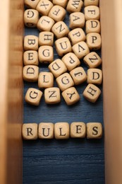 Photo of Word Rules made of cubes with letters on blue wooden table, flat lay