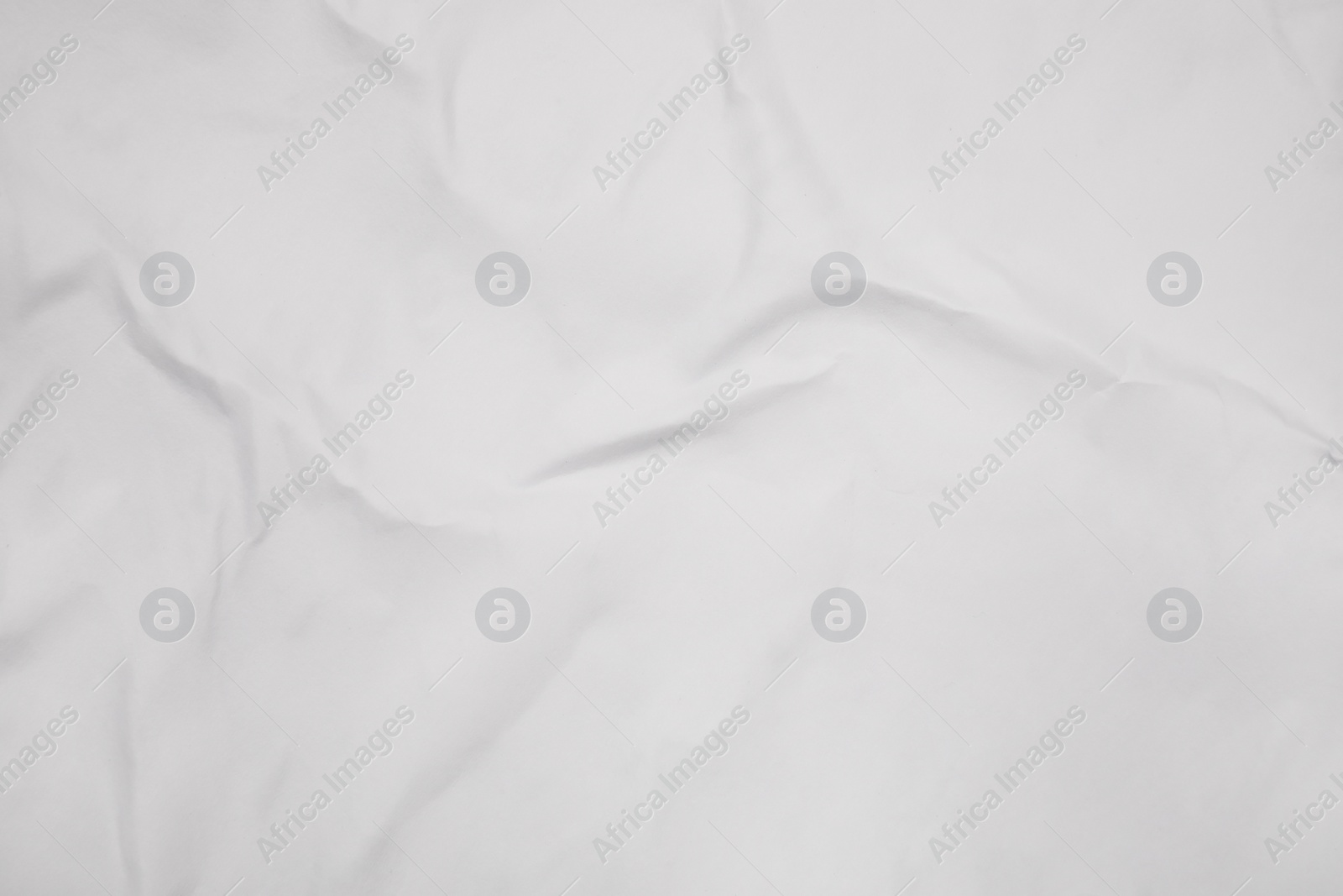 Photo of Top view of white creased blank poster as background, closeup