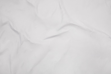 Photo of Top view of white creased blank poster as background, closeup