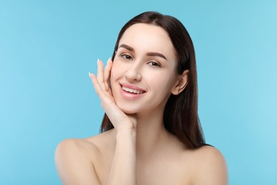 Photo of Portrait of beautiful young woman on light blue background