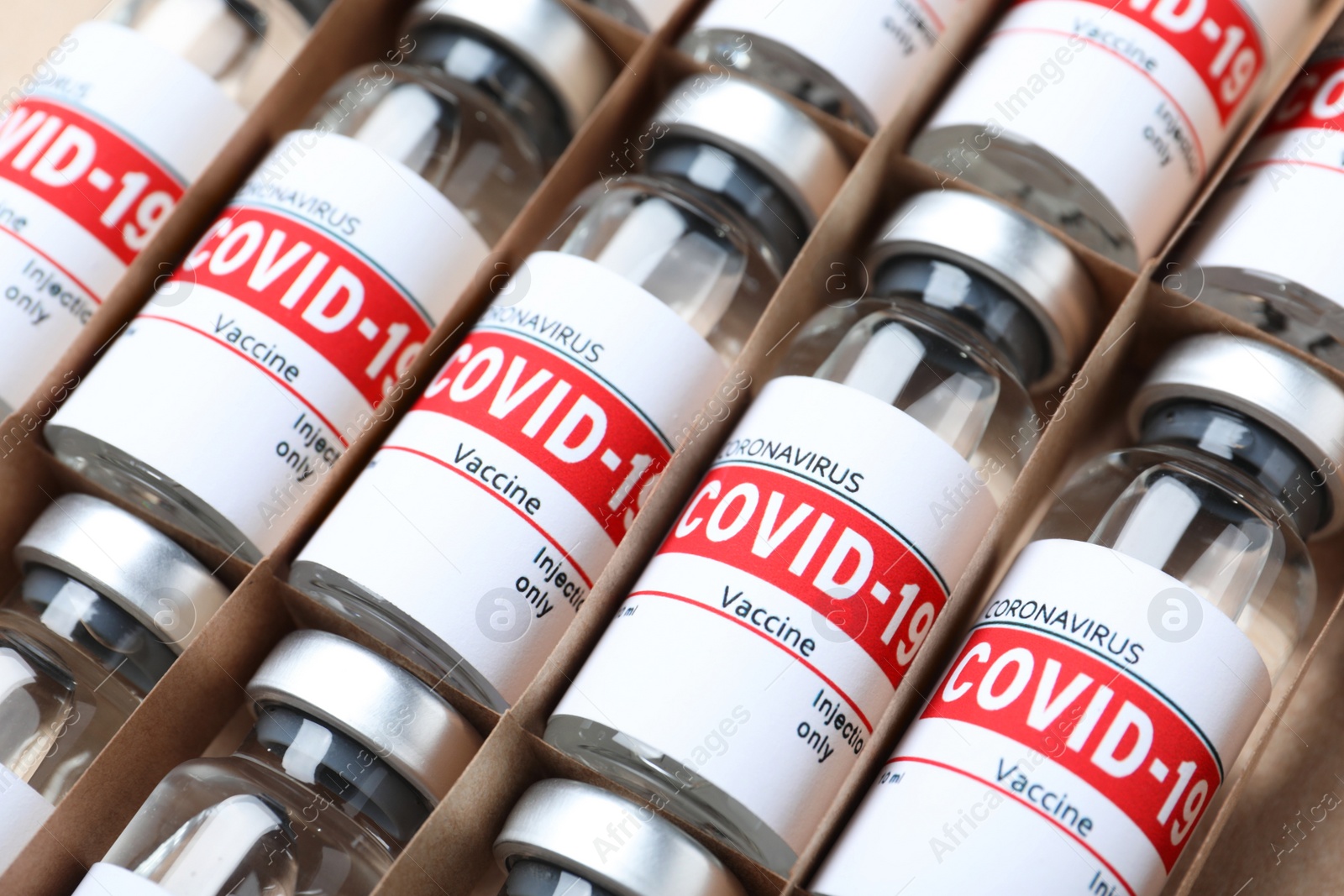 Photo of Glass vials with COVID-19 vaccine in package, closeup