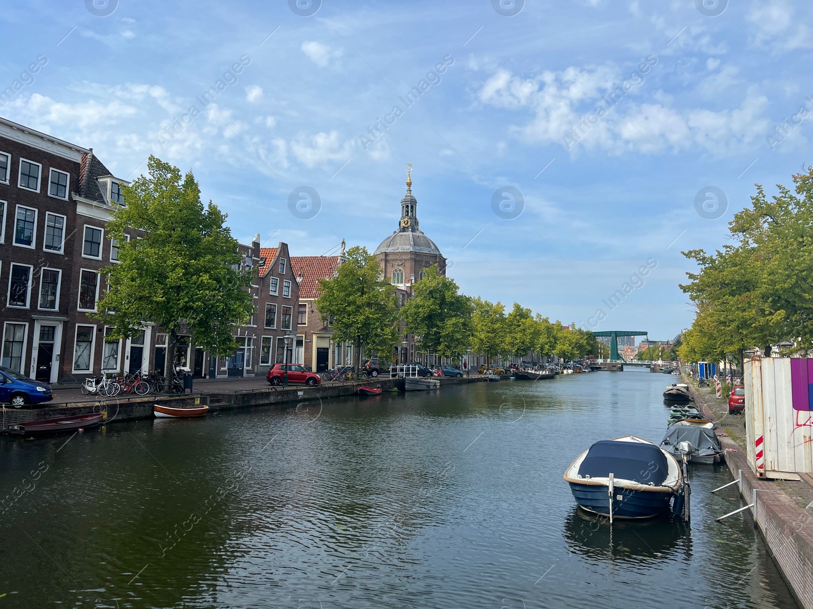 Photo of Leiden, Netherlands - August 28, 2022; Beautiful view of buildings near canal and boat on sunny day