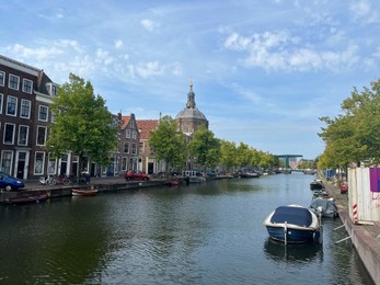Leiden, Netherlands - August 28, 2022; Beautiful view of buildings near canal and boat on sunny day