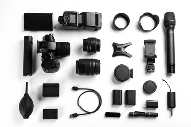 Photo of Composition with camera and video production equipment on white background, top view