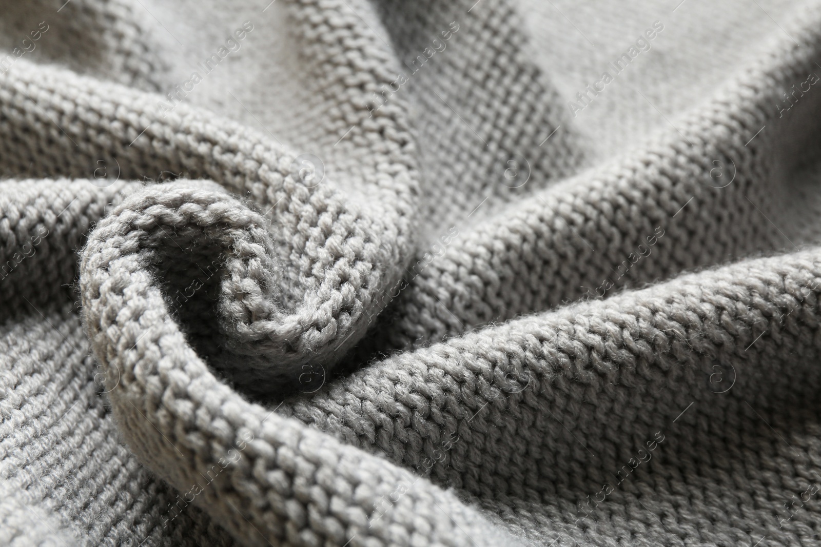 Photo of Beautiful grey knitted fabric as background, closeup