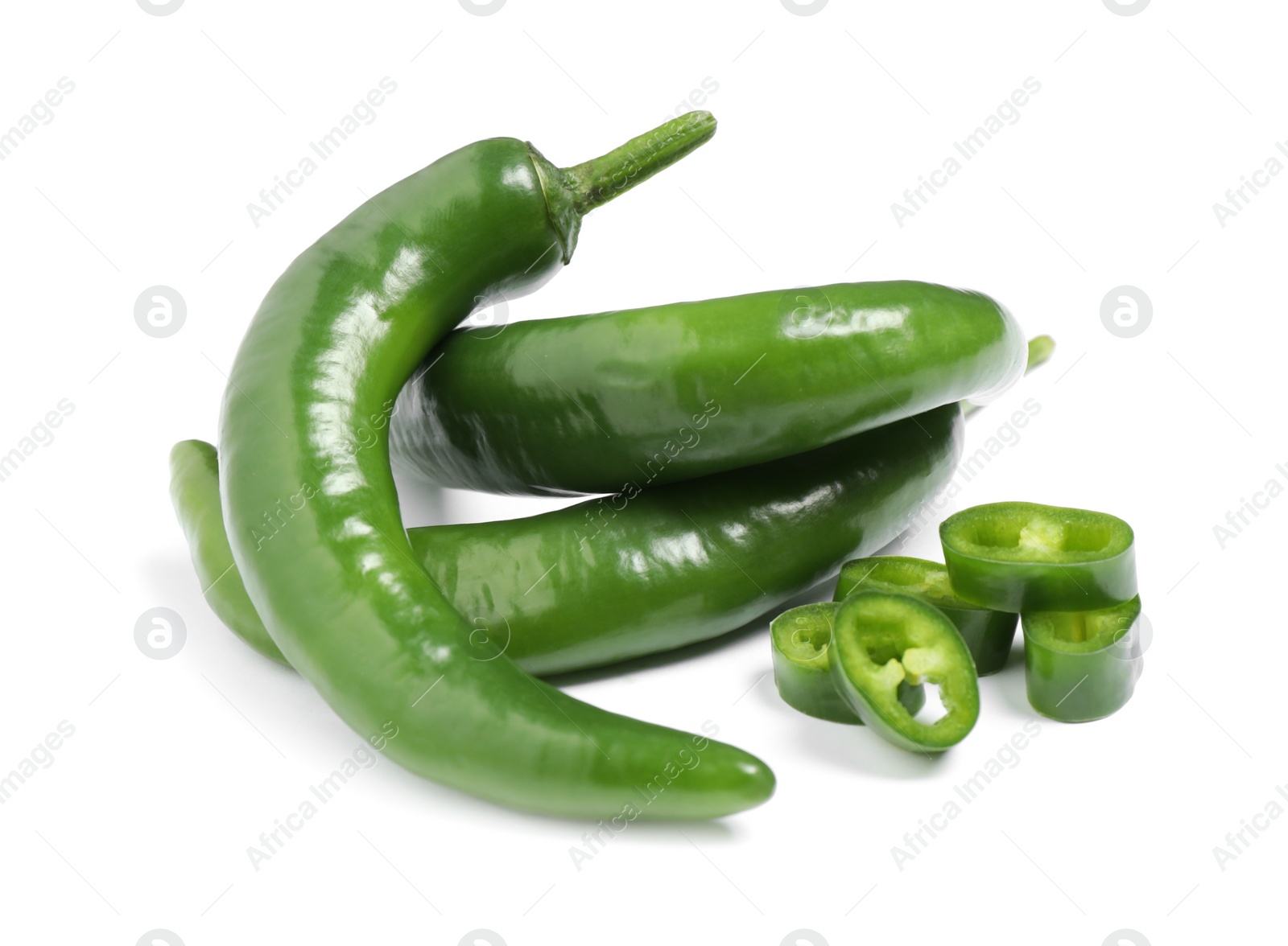 Photo of Cut and whole green hot chili peppers on white background