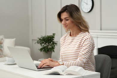 Online test. Woman studying with laptop at home