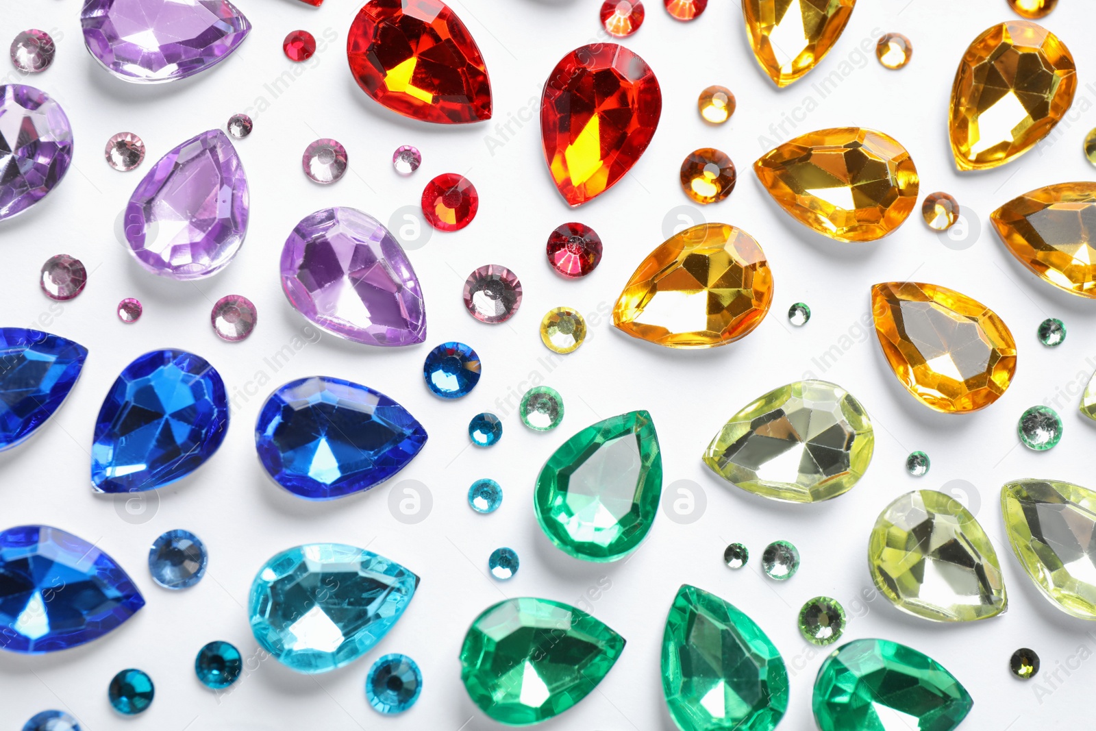 Photo of Different beautiful gemstones on white background, top view