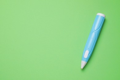 Photo of Stylish 3D pen on green background, top view. Space for text