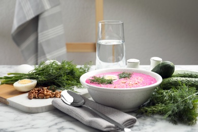 Photo of Delicious cold summer beet soup on white marble table