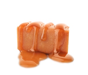 Delicious candy with caramel sauce on white background