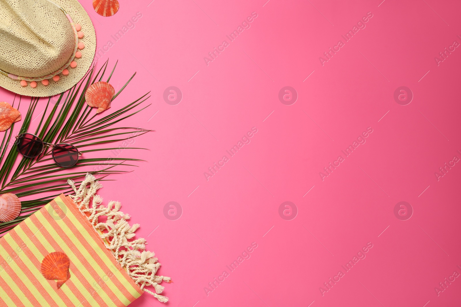 Photo of Flat lay composition with different beach objects on pink background, space for text