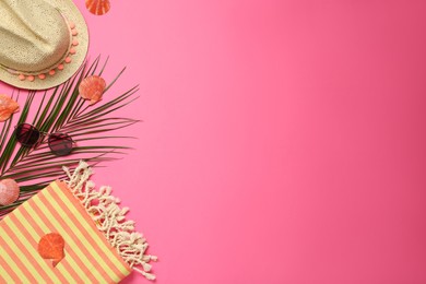 Flat lay composition with different beach objects on pink background, space for text