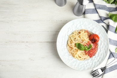 Photo of Flat lay composition with tasty pasta on white wooden table, space for text