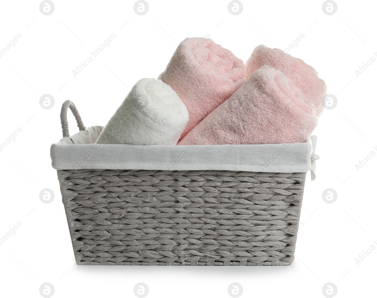 Photo of Rolled soft towels in basket on white background