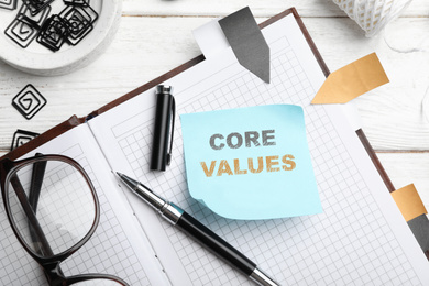 Image of Core values concept. Flat lay composition with stationery on white wooden table 