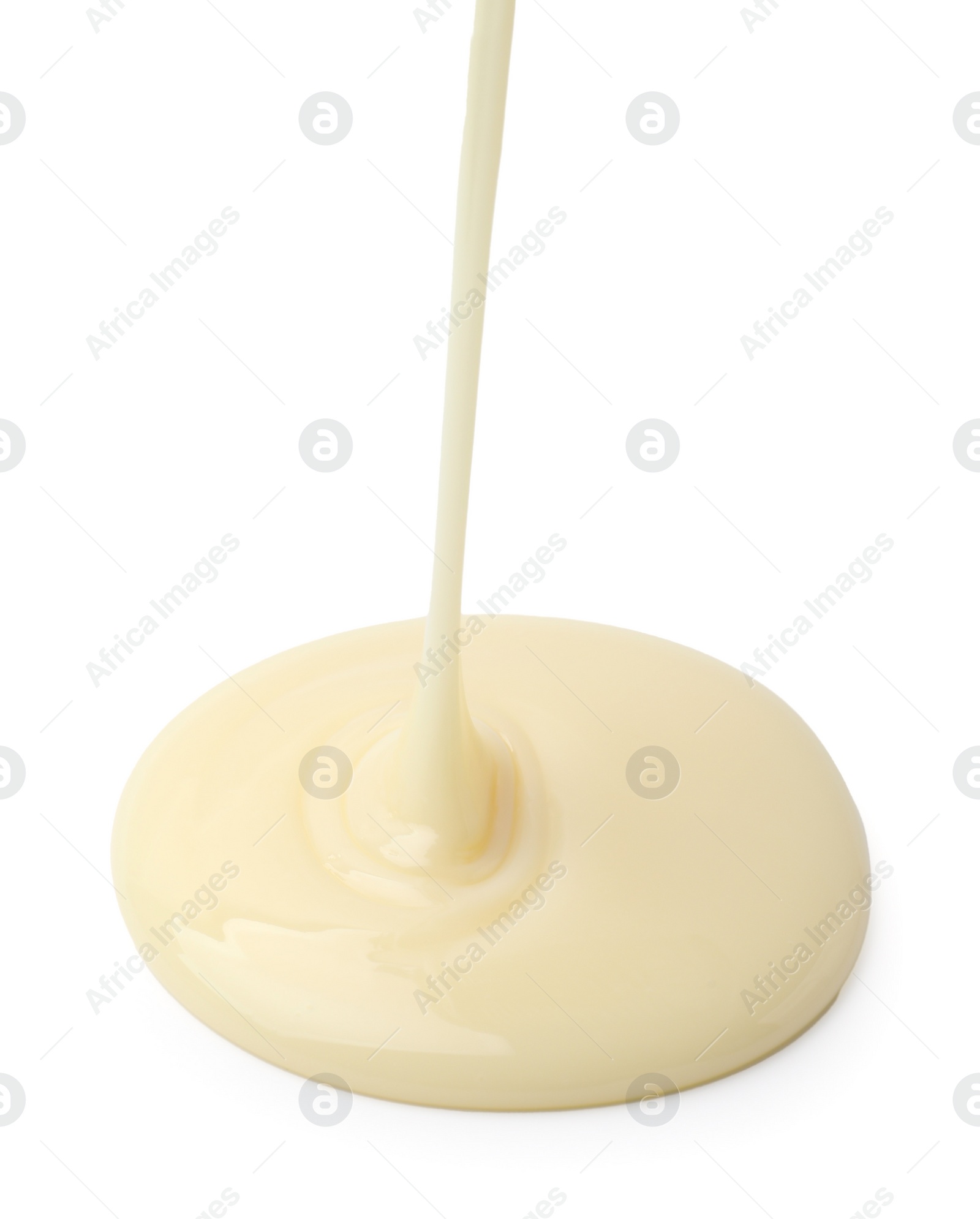 Photo of Pouring tasty condensed milk isolated on white
