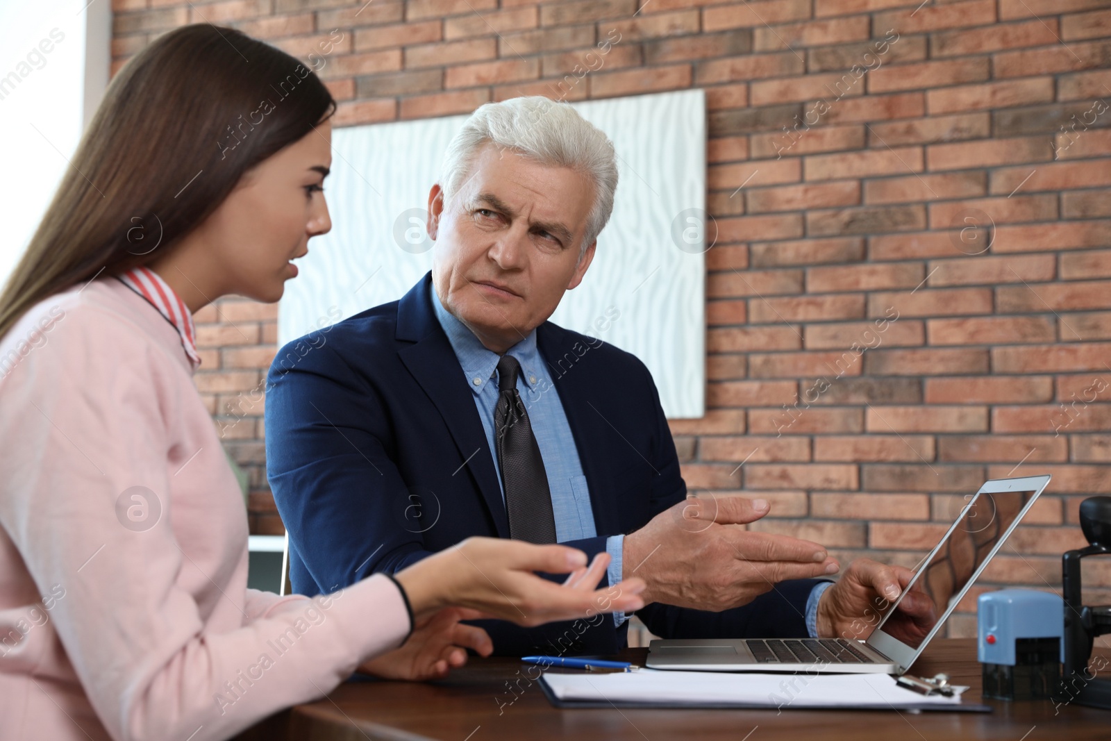 Photo of Senior notary working with client in office