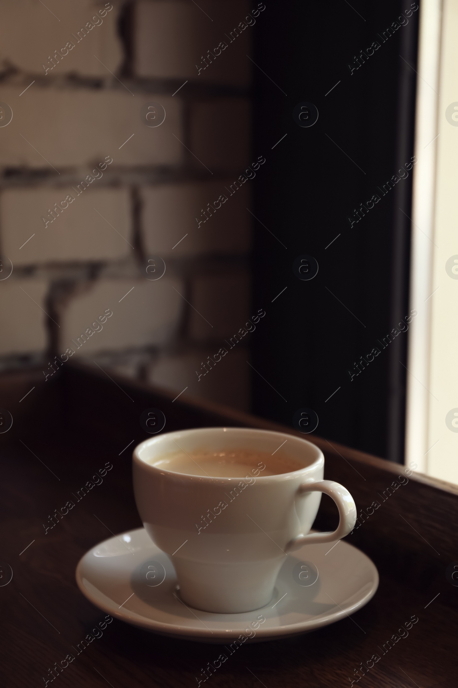 Photo of Cup of fresh aromatic coffee on table