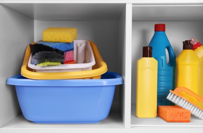 Photo of Different cleaning supplies and tools on shelves