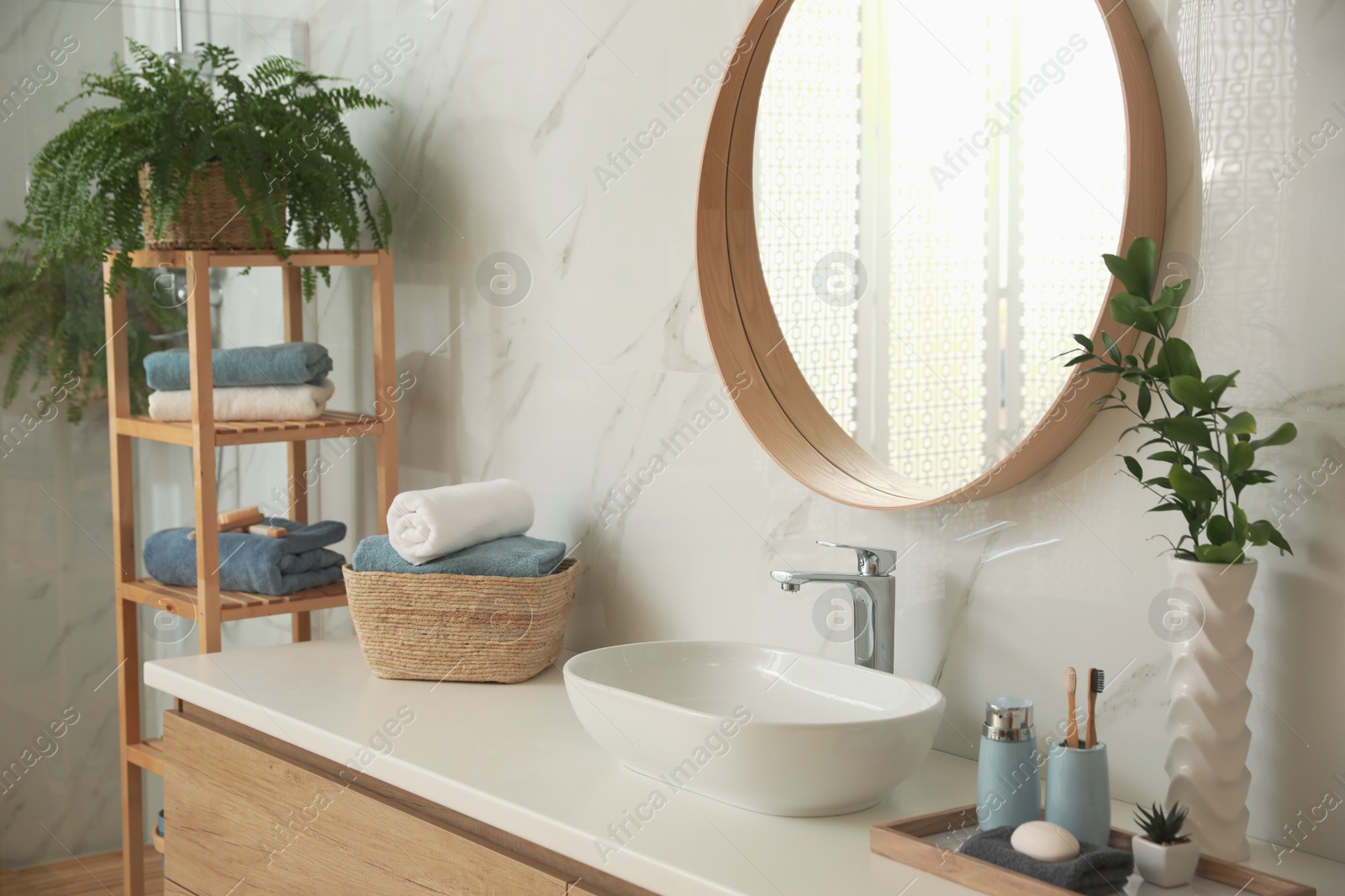 Photo of Stylish bathroom interior with countertop and mirror. Design idea