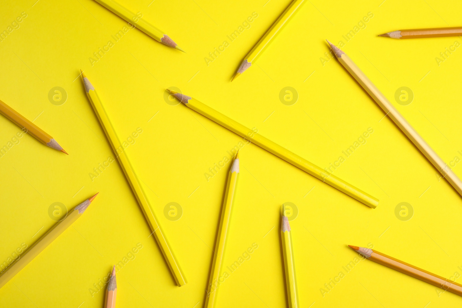 Photo of Flat lay composition with color pencils on yellow background