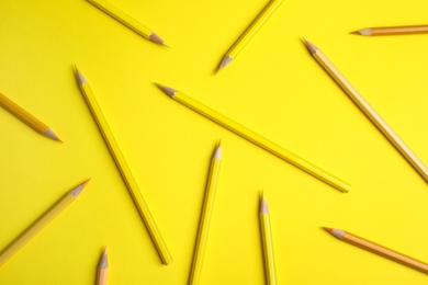 Photo of Flat lay composition with color pencils on yellow background