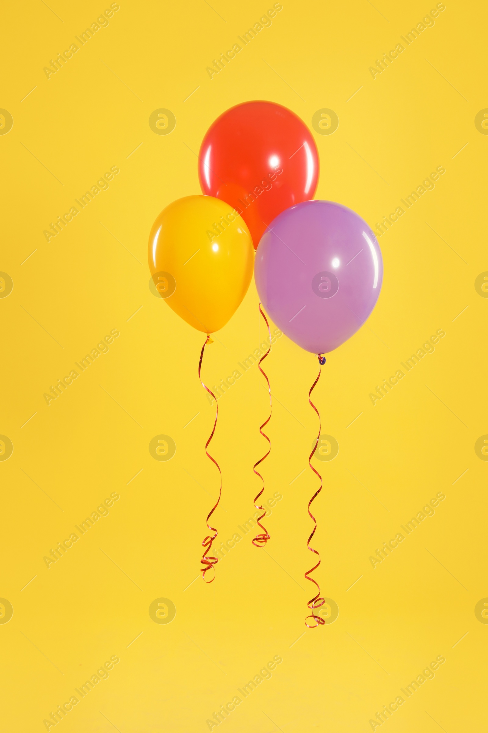 Photo of Bright balloons on color background. Celebration time