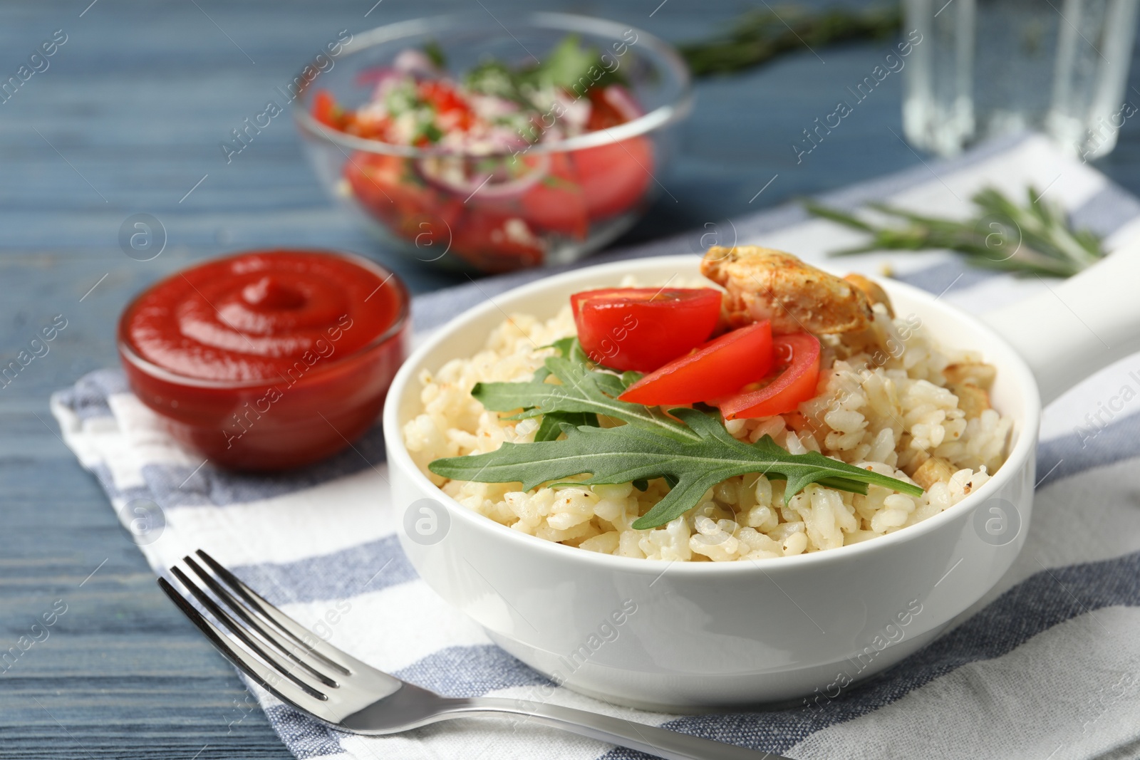 Photo of Delicious chicken risotto served in bowl on table