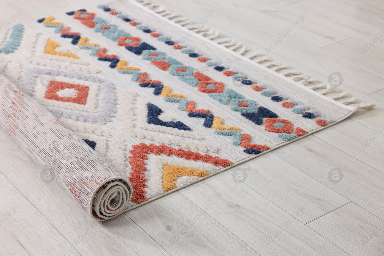 Photo of Rolled carpet with beautiful pattern on floor