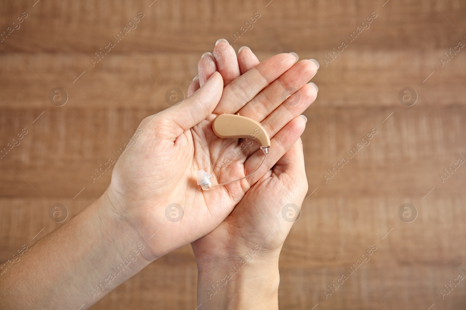 Photo of Woman with hearing aid on blurred background, top view