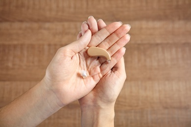 Photo of Woman with hearing aid on blurred background, top view