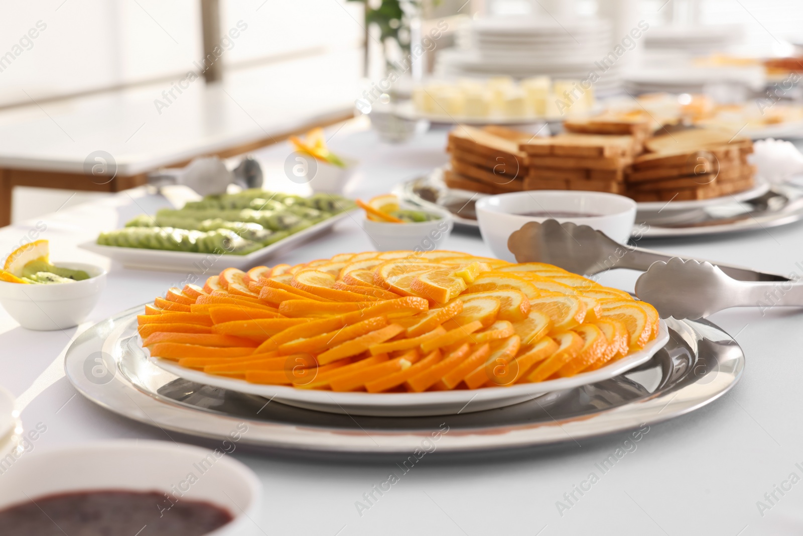 Photo of Different meals for breakfast on white table indoors. Buffet service