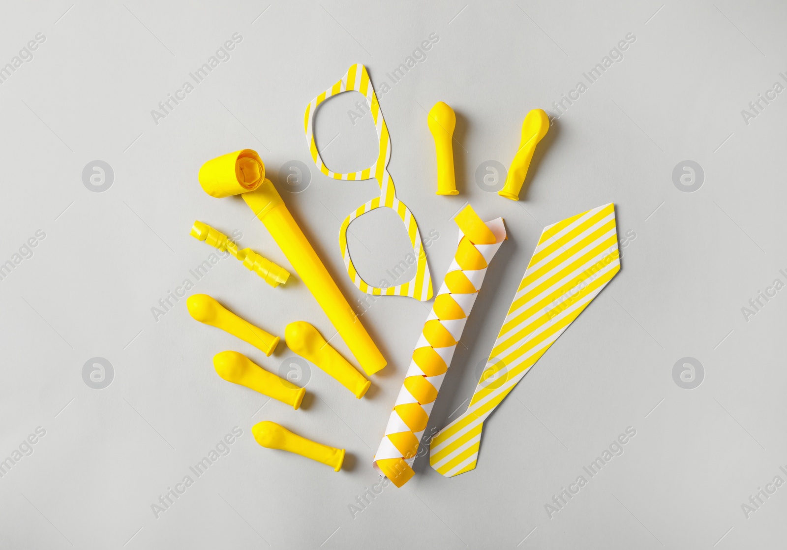 Photo of Different clown's accessories on light background, flat lay
