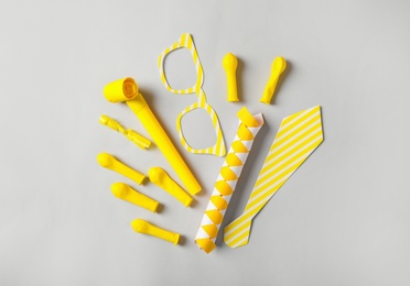 Photo of Different clown's accessories on light background, flat lay