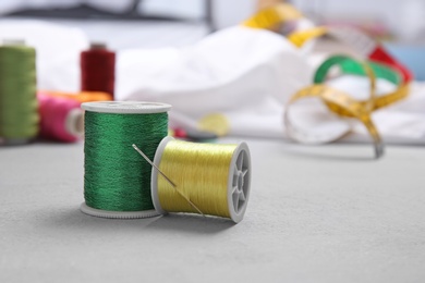 Bobbins with threads on table. Tailoring accessories