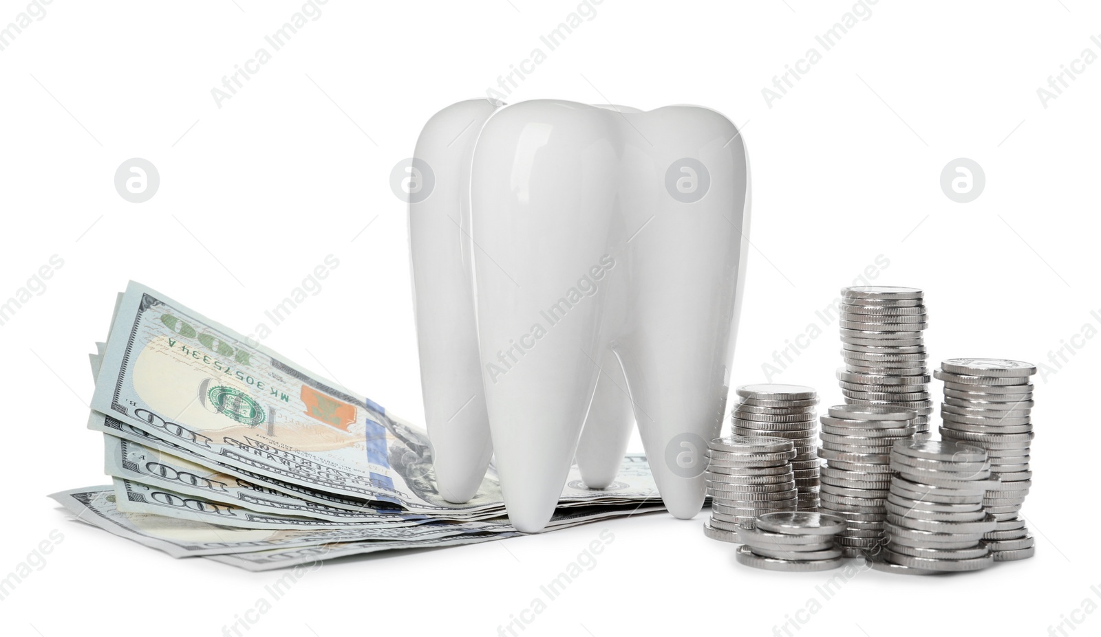 Photo of Ceramic model of tooth, dollar banknotes and coins on white background. Expensive treatment