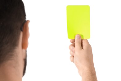 Referee holding yellow card on white background, closeup