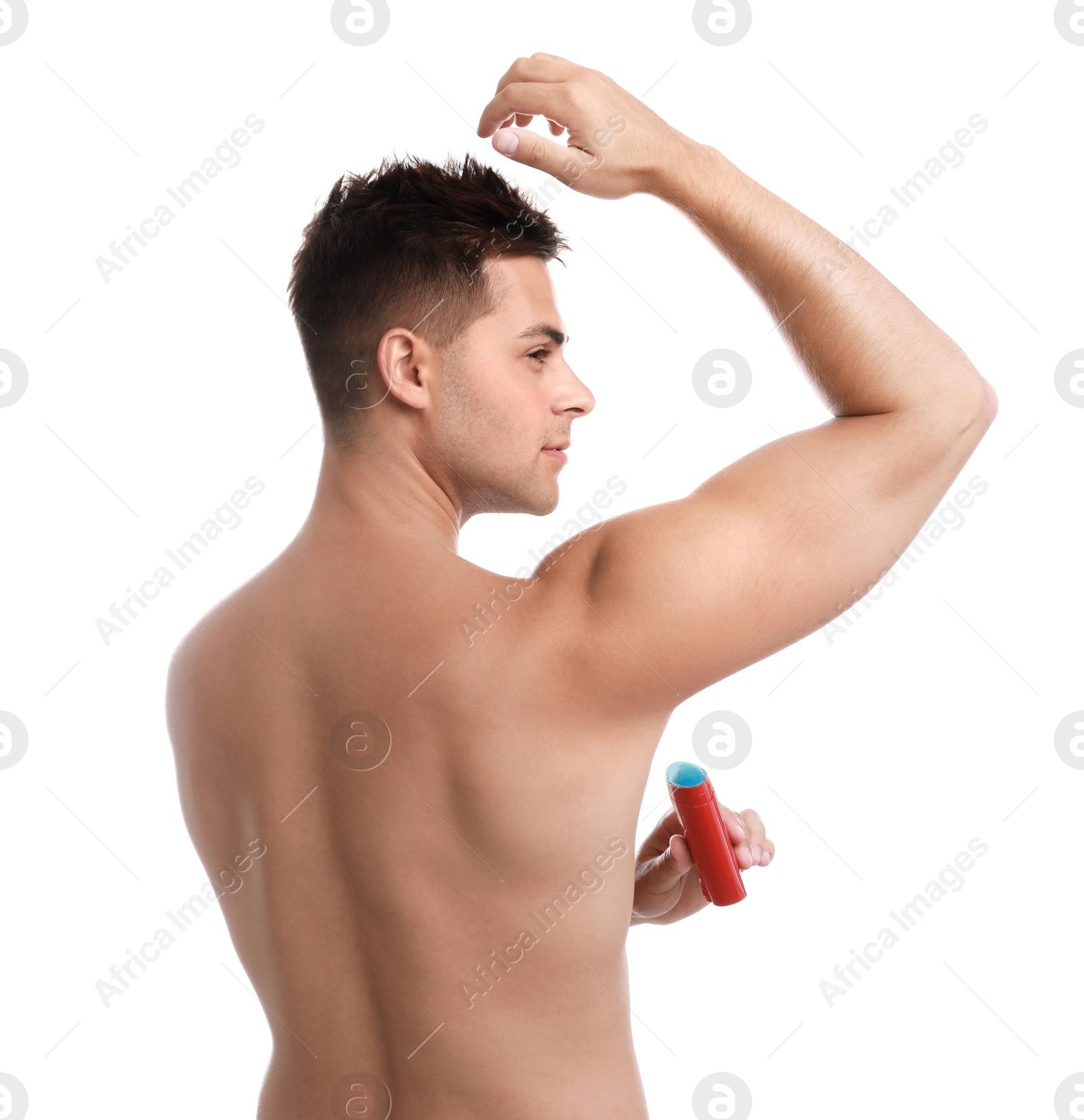 Photo of Young man applying deodorant to armpit on white background